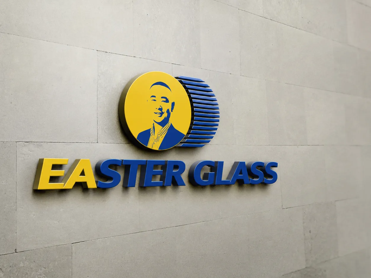 Easter Glass emblem and company name mounted on a light stone wall