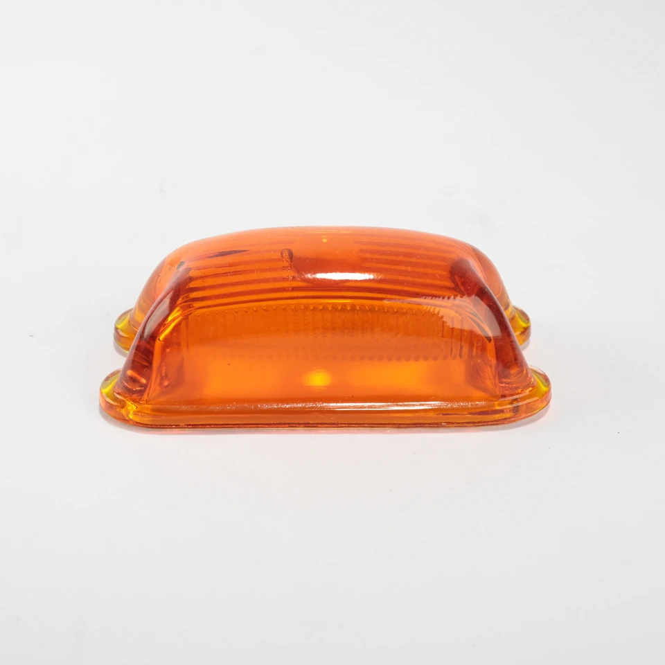 Red translucent glass dome with a smooth curved body and notched circular flange