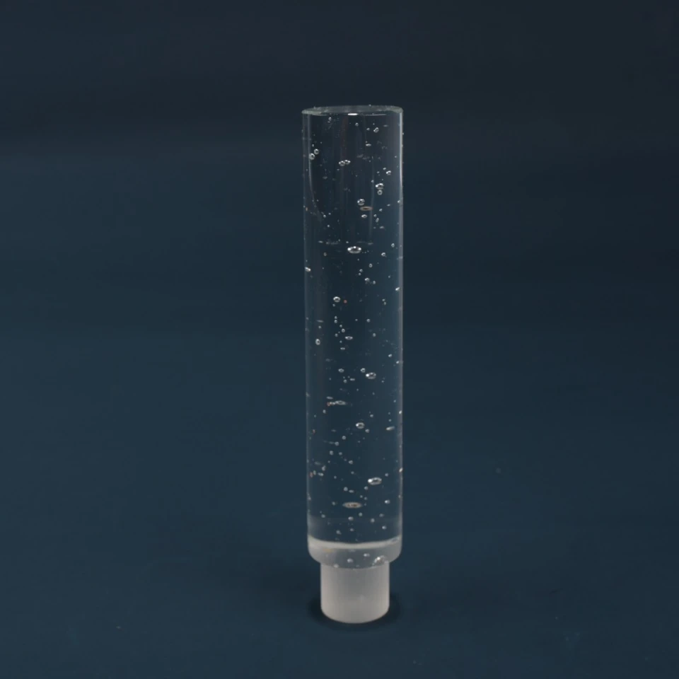 Second upright view of a clear cylindrical glass tube with bubbles