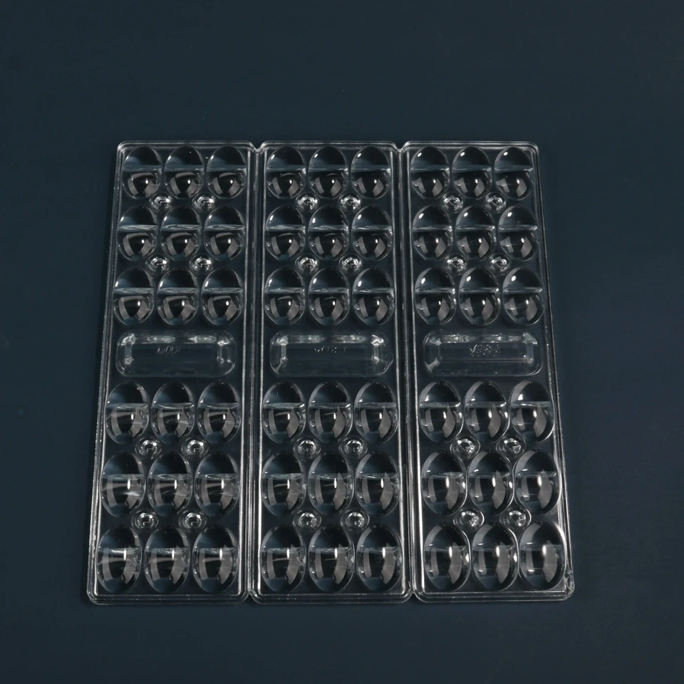 Rectangular clear lighting glass panel with repeated raised lens elements in three grouped columns