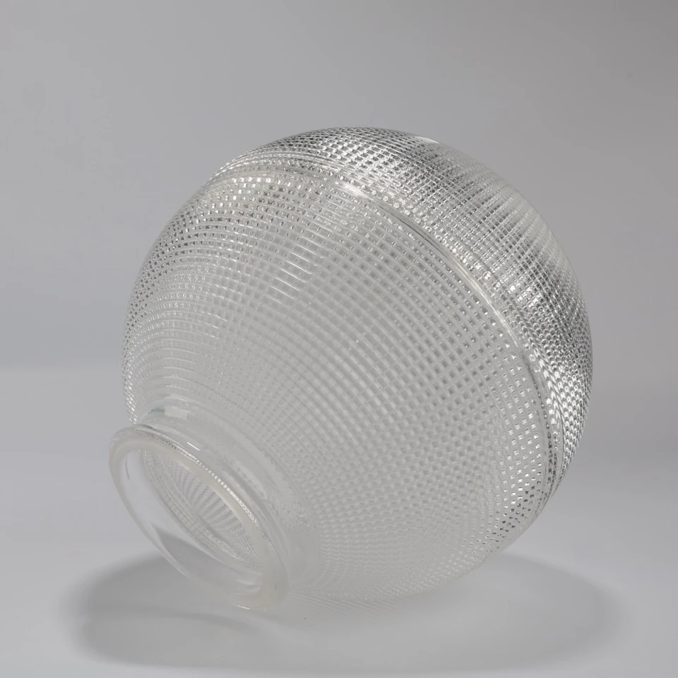 Clear prismatic globe shade standing on its integral mounting neck