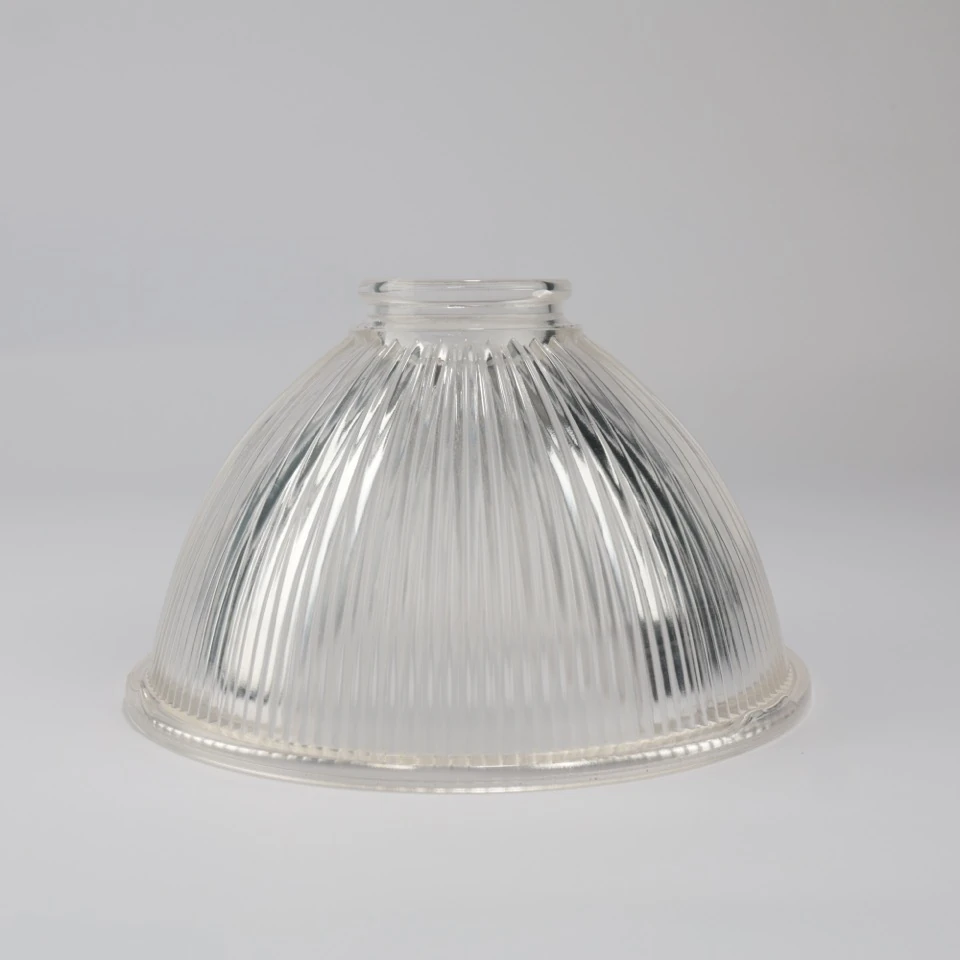 Clear ribbed bell glass shade standing with its narrow neck at the top