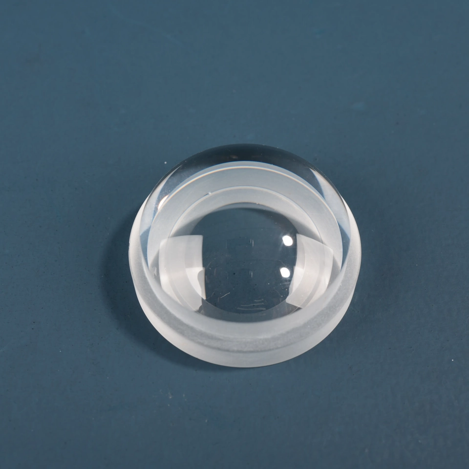 Clear domed glass lens with a stepped circular base viewed at an angle