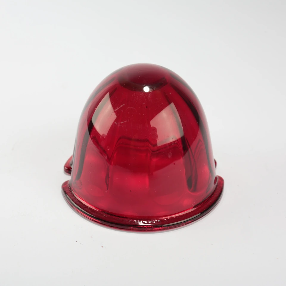 Red translucent glass dome with a smooth curved body and notched circular flange