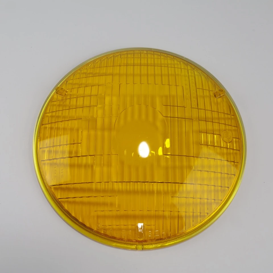Golden yellow shallow domed headlamp lens with patterned surface